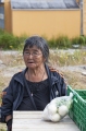 LOCAL INUIT WOMAN SELLING TURNIPS