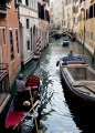 GONDOLIER PLYING THE CANALS IN VENICE ITALY