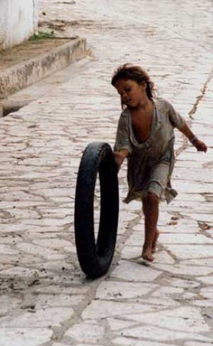 Child Playing with a Tyre on Granma Island 